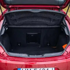Bagażnik czerwonego Alfa Romeo Giulietta, gotowy na podróż.