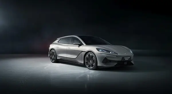Elegancki, srebrny Denza Z9 GT z futurystycznym designem stoi na ciemnym tle.